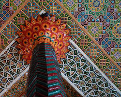 Traditional Kashmiri Khatamband ceiling featuring precisely fitted pine and deodar wood pieces arranged in intricate geometric patterns using interlocking joints.